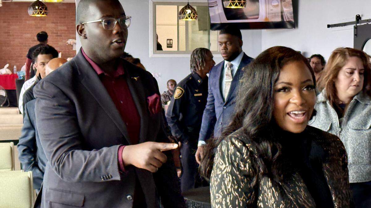 U.S. Rep. Jasmine Crockett greets well-wishers at Nana’s Kitchen in Fort Worth, Texas, Dec. 21, 2025. She is accompanied by staffer Kendyll Locke.