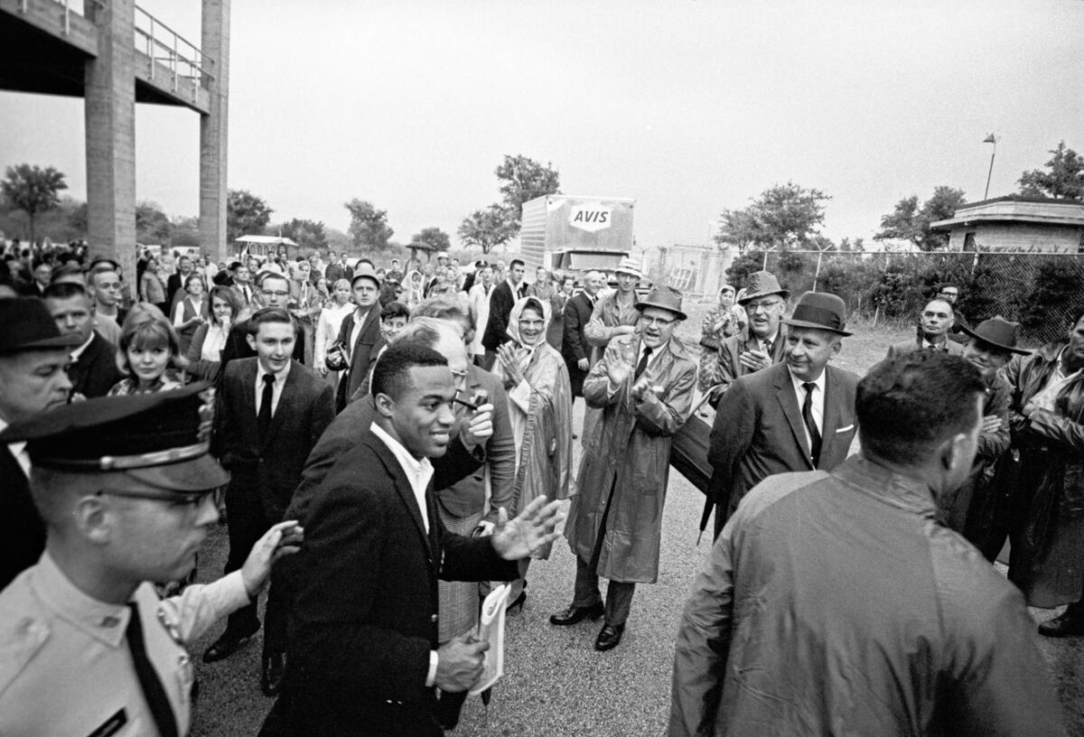 Jerry Levias, first African American football player for Southern Methodist University, leaves the stadium at Texas Christian University’s Amon G. Carter Stadium escorted by patrolman G. R. Killough and plainclothes officer L. W. Spinks, extreme left, after the TCU-SMU football game in 1966.