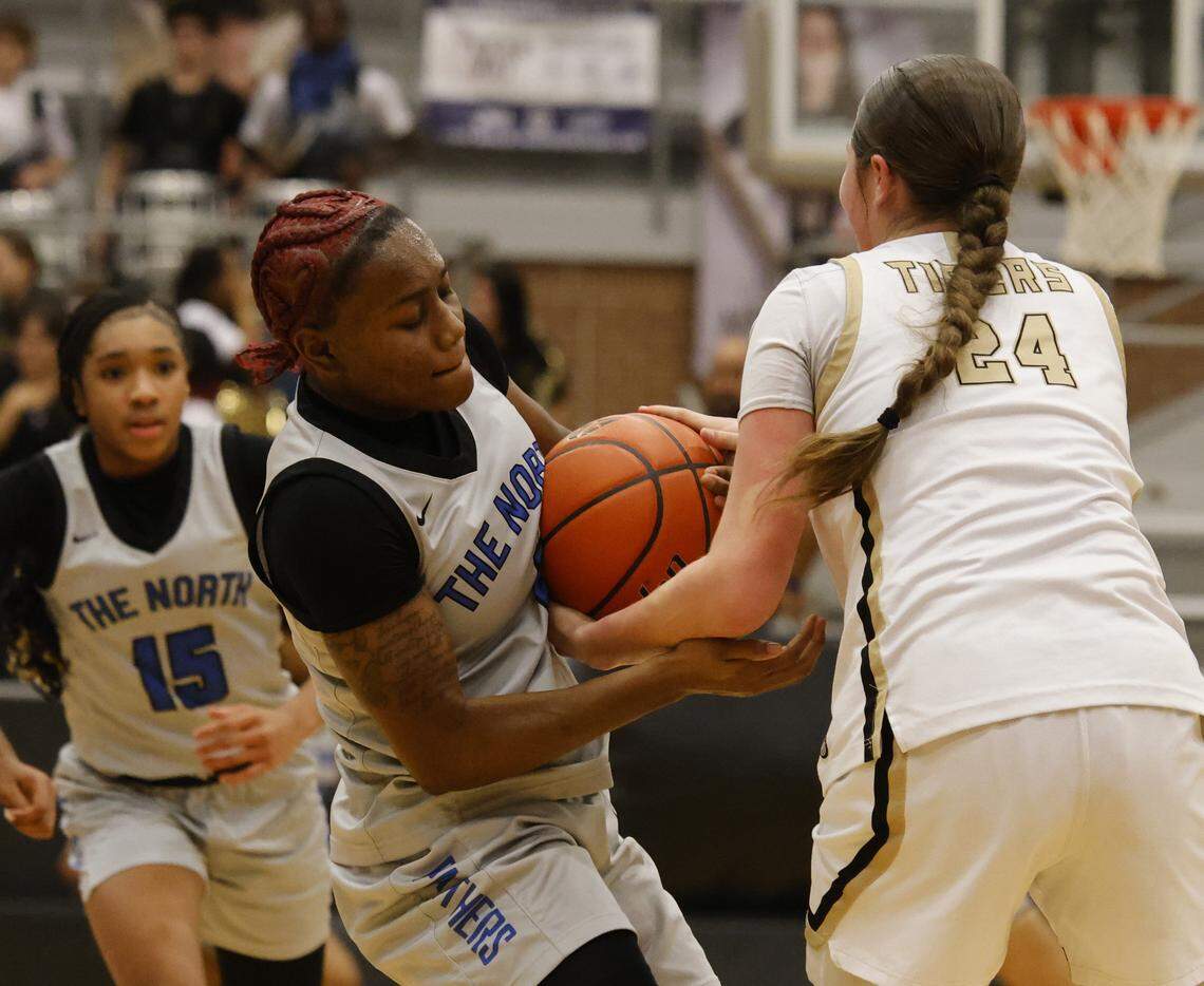 North Crowley shooting guard Jamari Milton (1) and Mansfield shooting forward Kylie Farnan (24) tie up for posession during the first half of a UIL girls basketball game between North Crowley and Mansfield at Mansfield High School in Mansfield, Texas, Tuesday Jan. 20, 2026