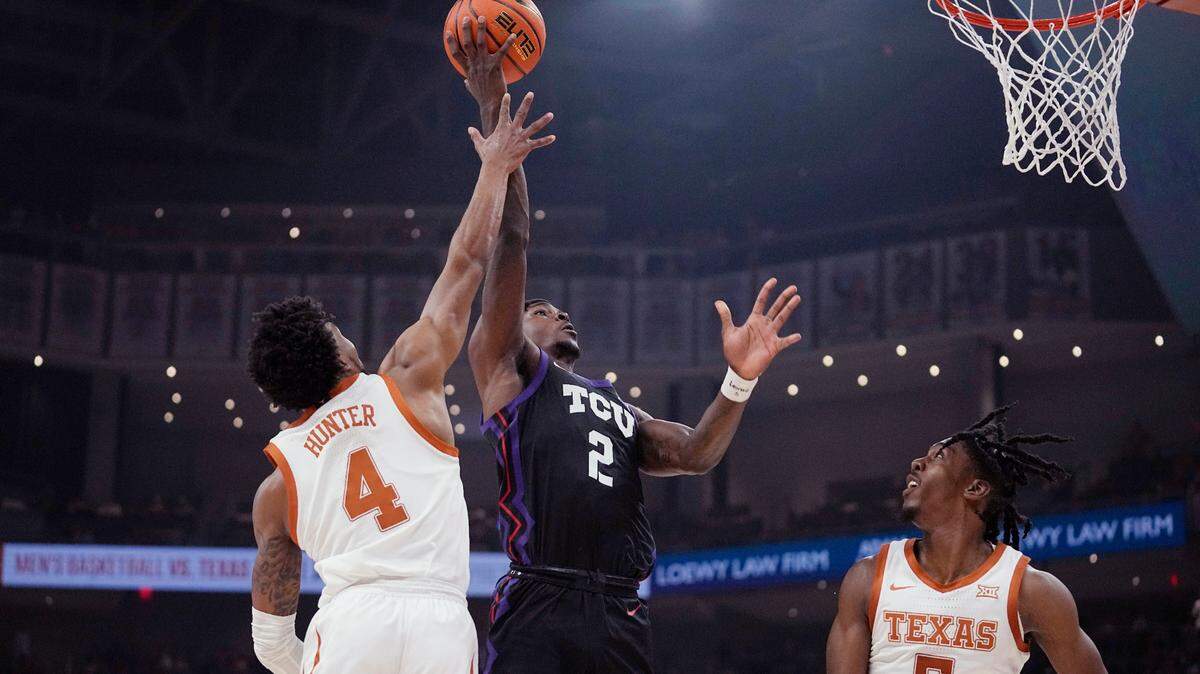 TCU forward Emanuel Miller (2) drives to the basket against Texas guard Tyrese Hunter (4) during the first half of an NCAA college basketball game in Austin, Texas, Wednesday, Jan. 11, 2023. (AP Photo/Eric Gay)
