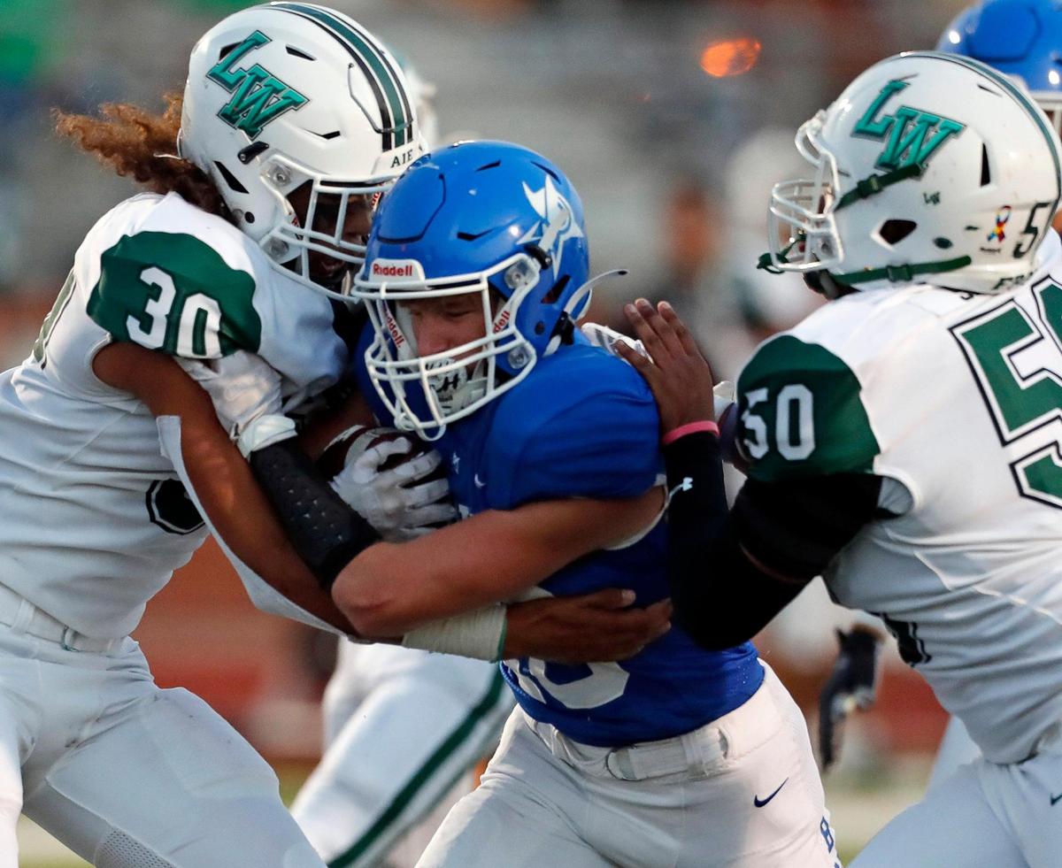 Lake Worth linebacker Raul Alvarez (30) and lineman Chris Satcher (50) attempt to keep Joshua running back Kolby Smith (40) from scoring during a high school football game at Owl Stadium in Joshua, Texas, Friday, Sept. 10, 2021. Lake Worth led Joshua by one at the half. (Special to the Star-Telegram Bob Booth)