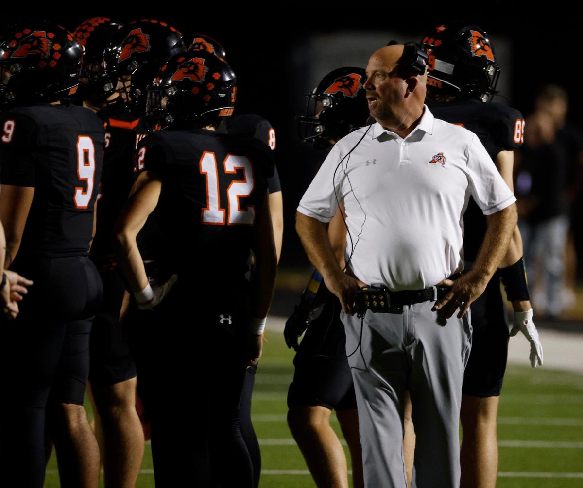 Aledo head coach Robby Jones listens in during a time out during a UIL football game at Buchanan Stadium in Aledo Texas, Friday, Oct. 04, 2024.