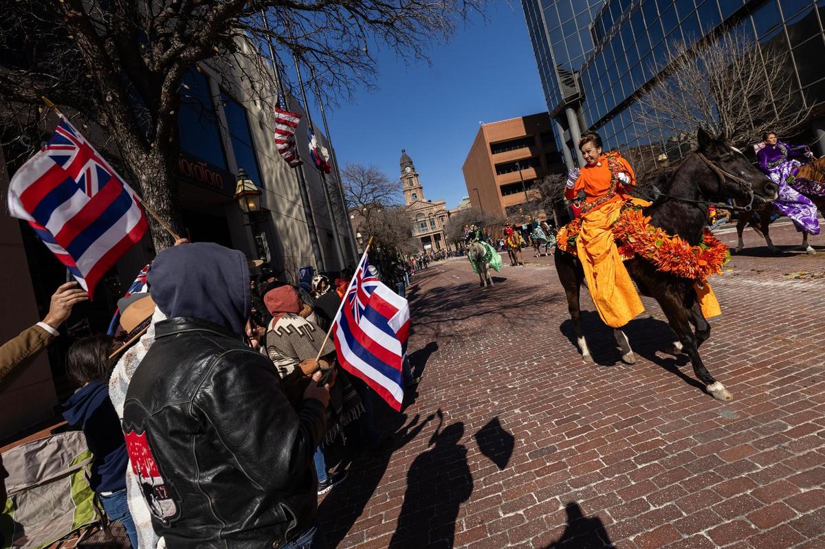 Supporters of the Hawaii Pa’u Riders cheers them on as they make their way down Main Street during the Fort Worth Stock Show All Western Parade in downtown Fort Worth on Saturday, Jan. 18, 2025.