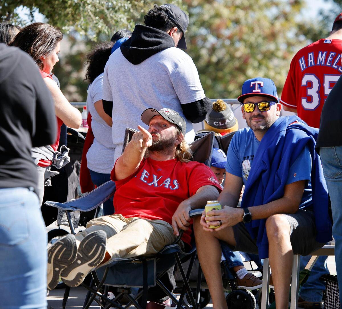 JJ Shine and Cody Hiler faced away from the street to keep the sun out of their eyes during the Texas Rangers World Series Parade in Arlington, Texas, Friday, Nov. 03, 2023. (Special to the Star-Telegram Bob Booth)