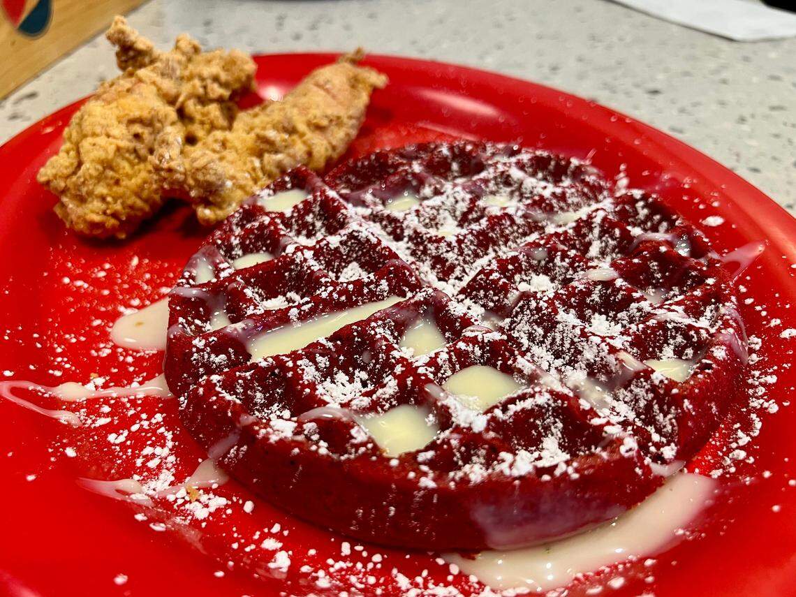 A red velvet waffle with fried catfish fillets at Breakfast Brothers in Arlington.