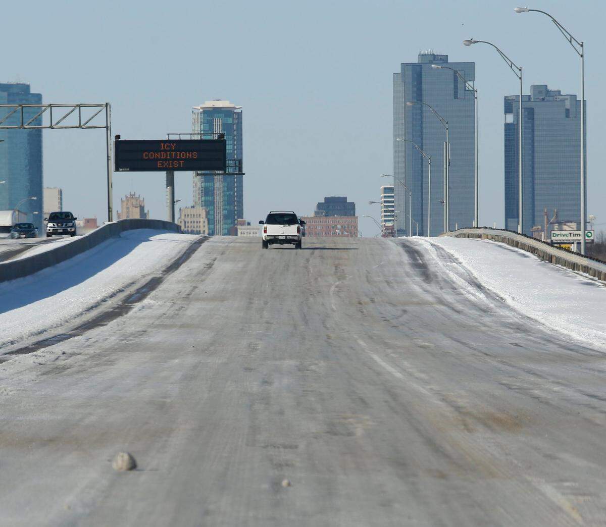 March 5, 2015: Warning signs and sanded highway made morning commutes slow due to ice and snow in Fort Worth.