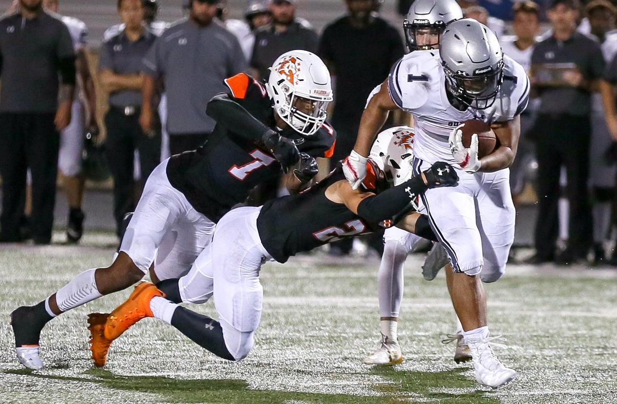 Denton Guyer running back Kaedric Cobbs (1) drags Aledo tacklers during the second half, Friday night, August 30, 2019 played at Bearcat Stadium in Aledo, TX.