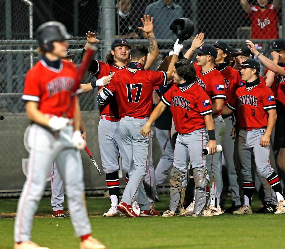 Mansfield Legacy left fielder Hayden Guerin (17) is welcomed back to the dugout after scoring during the fifth annual Drew Medford Memorial Tournament on March 12, 2021, at Legacy. Legacy defeated Arlington Martin 5-0.