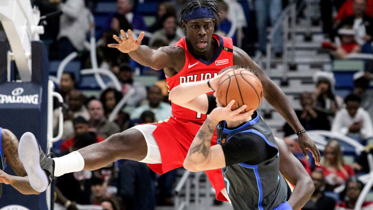 New Orleans Pelicans guard Jrue Holiday (11) guards Dallas Mavericks forward Luka Doncic (77) in the first half of an NBA basketball game in New Orleans, Wednesday, Dec. 5, 2018. (AP Photo/Scott Threlkeld)