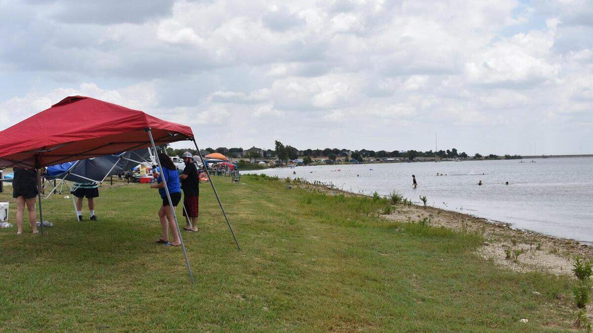 Lake Pat Cleburne is the source of the city of Cleburne’s water supply. The city is embroiled in court battles over whether the water supply is threatened by a company dumping waste nearby. Here, people gather at the lake for a Fourth of July celebration.