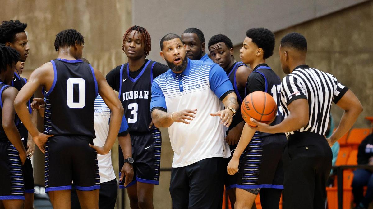Dunbar head coach Swarn Lacy glances back to the score board during a time out in the second quarter of a high school basketball game at Wilkerson Greines Activity Center in Fort Worth, Texas, Saturday, Jan, 27, 2024.