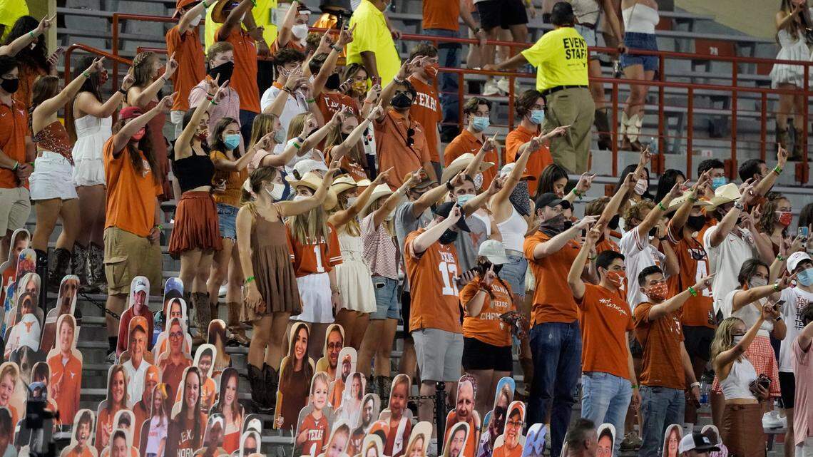 Fans join in singing “The Eyes of Texas” after Texas defeated UTEP in September. Students are refusing to give campus tours over a dispute about a plaque the the lyrics hanging in the Admissions Welcome Center.