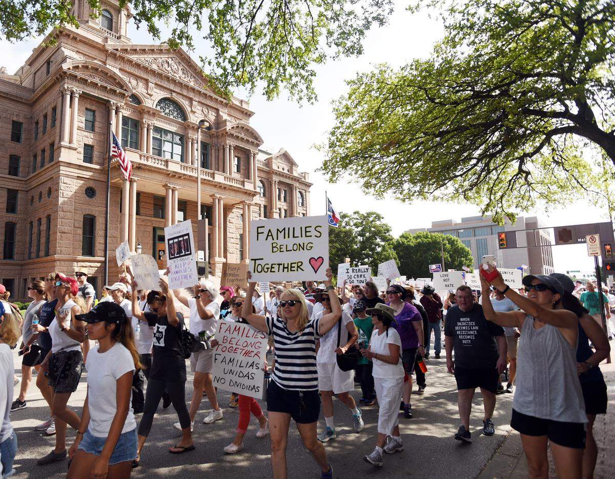 Demonstrators pass in front of the Tarrant County Courthouse to the Federal Building in downtown Fort Worth, Texas, as part of the worldwide Families Belong Together March and Rally on Saturday, June 30, 2018. The march is to highlight the unfairness of current U.S. immigration policies.