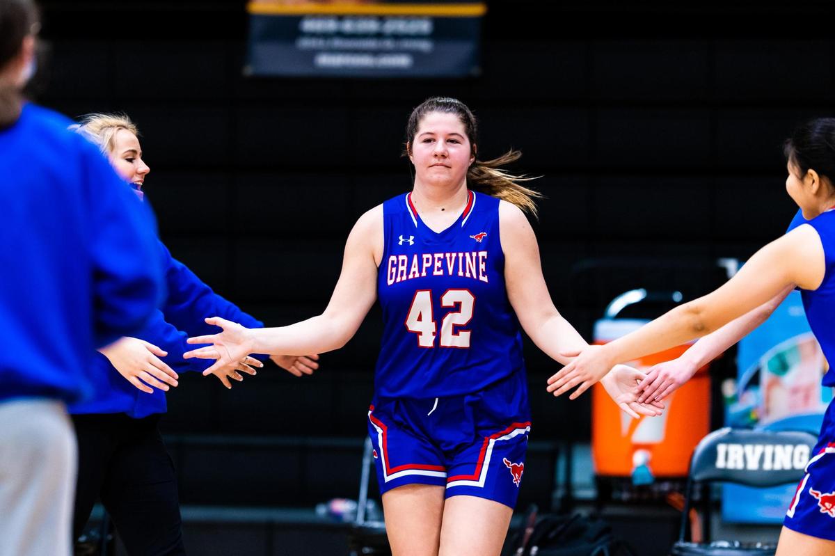 Emery Kirkpatrick (42) high fives her teamates during player introductions before an Area round playoff game between Grapevine and Mansfield Summit at Irving High Shcool on February 20, 2021. Photo by Matt Smith (Special to the Star-Telegram).