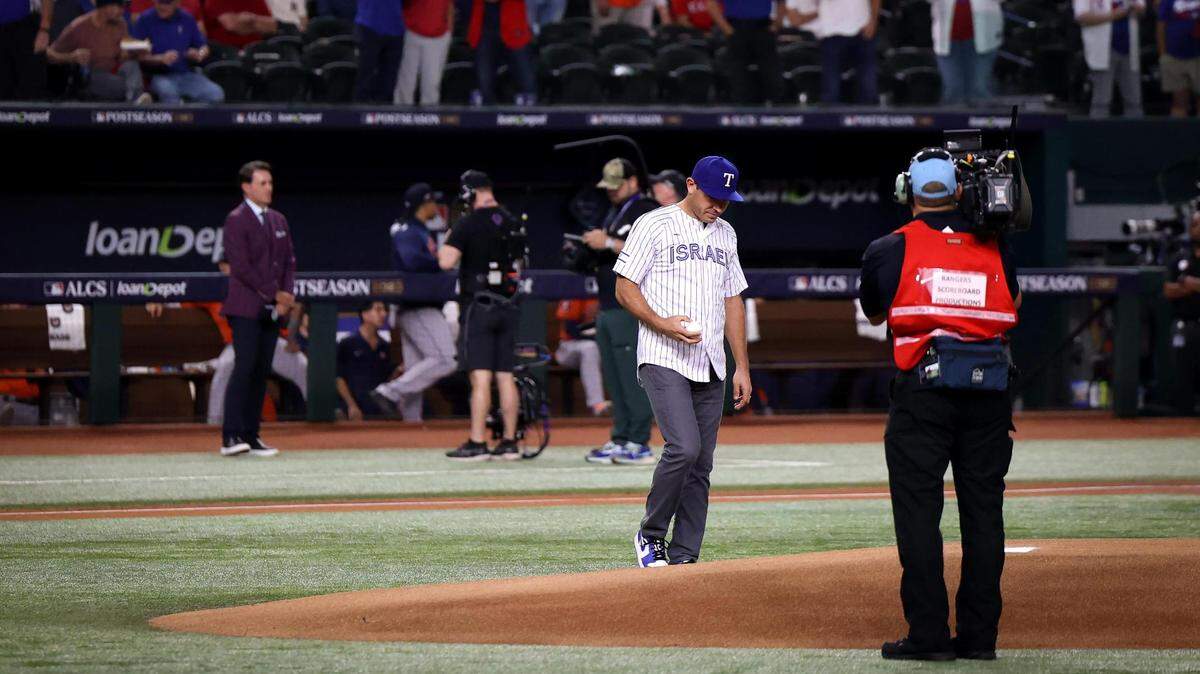 Former Rangers second baseman Ian Kinsler, wearing an Israel jersey, approaches the mound to throw the ceremonial first pitch of Game 3 of the ALCS at Globe Life Field in Arlington on Wednesday, October 18, 2023.