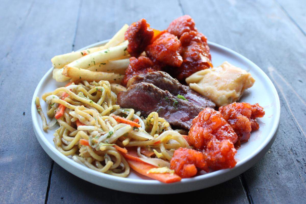 A full plate of pan-asian dishes at Soy Cowboy at Loews Hotel in Arlington. Veggie Soba Noodles, Orange Chicken, Wagyu Steak, and a Lobster Wonton.