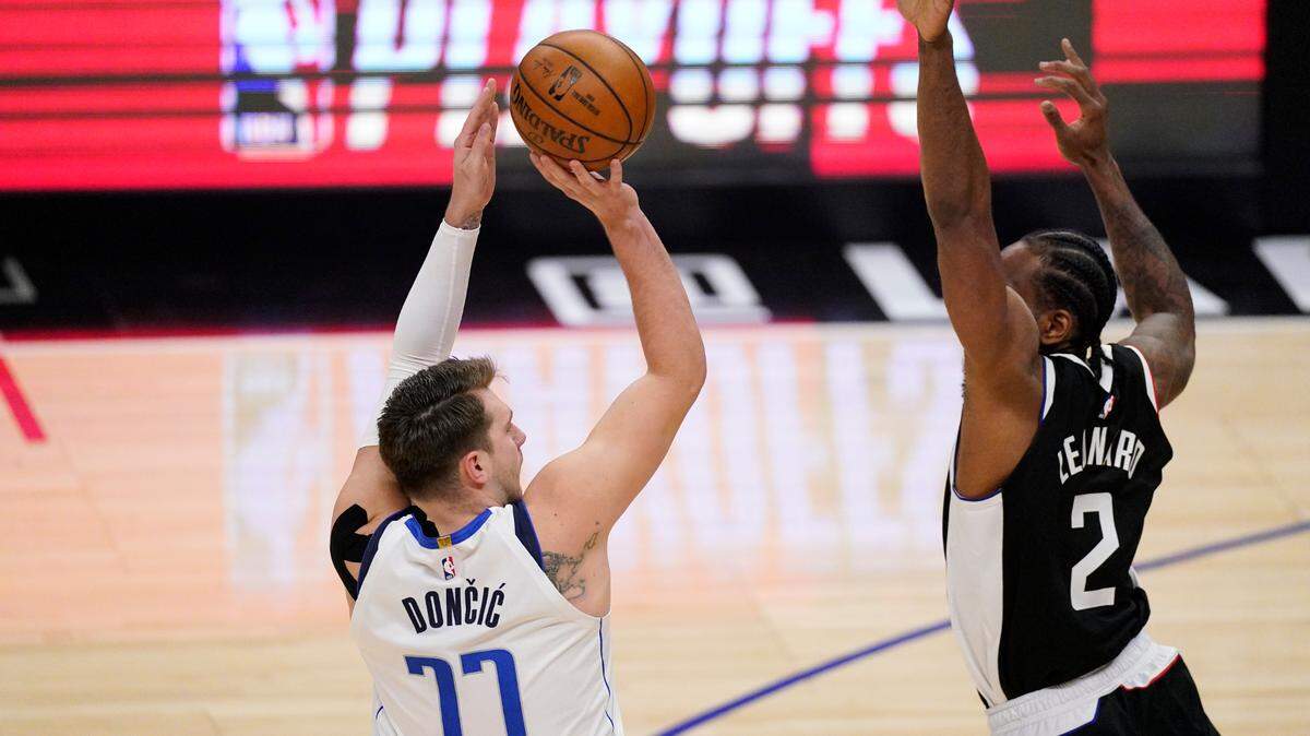 Dallas Mavericks guard Luka Doncic, left, finished with 42 points, 14 assists and eight rebounds in Wednesday’s Game 5 victory over the Los Angeles Clippers and Kawhi Leonard.