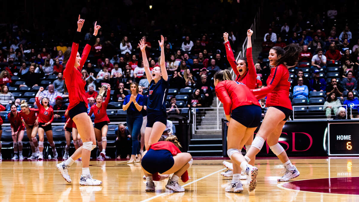 The Mustangs celebrate a big point late in set 5 during the 5A state semifinal game between Grapevine and Comal Canyon at the Curtis Culwell Center in Garland on November 19, 2021. Photo by Matt Smith. Special to the Star-Telegram.