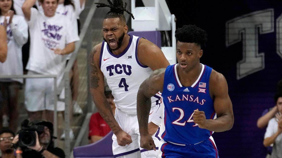 TCU center Eddie Lampkin Jr. (4) celebrates in front of Kansas’ K.J. Adams Jr. (24) after dunking on Monday during their Big 12 game.