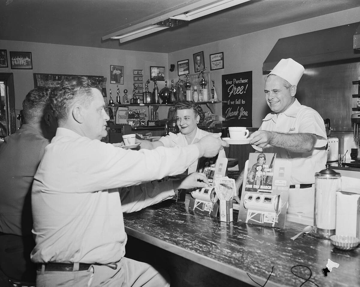 Jan. 27, 1952: Fred Cooper, left, of 2807 NW 26th St., and Carl Dorrough of 465 Bryan, say thanks for their coffee by dropping coins into a March of Dimes container at Topsy’s Cafe, 929 University Drive. (The site is now a Salsa Limon. This diner was moved intact and became another Salsa Limon at 5012 White Settlement Road.) Servers are Mildred Long and Jack Allen, the owner.