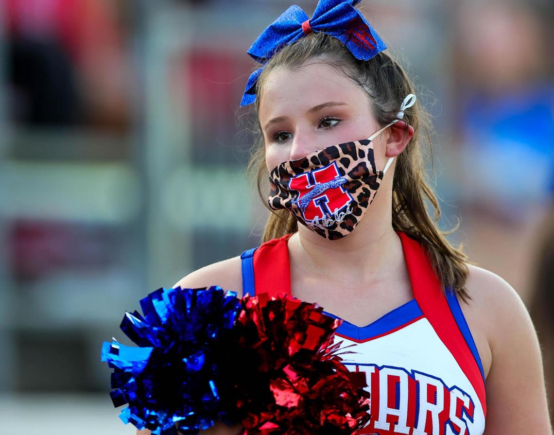 A Midlothian Jaguar cheerleader is wearing her mask during the High School football game between Wichita Falls Hirschi and the Midlothian Jaguars, Friday night, August 28, 2020 played at Midlothian ISD Multi-Purpose Stadium in Midlothian, TX.