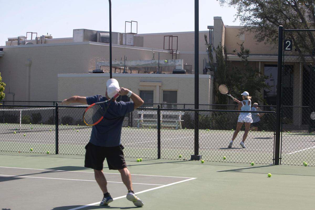 Members play tennis on the courts at Ridglea Country club in Fort Worth, Texas, on Saturday, July 23, 2022.