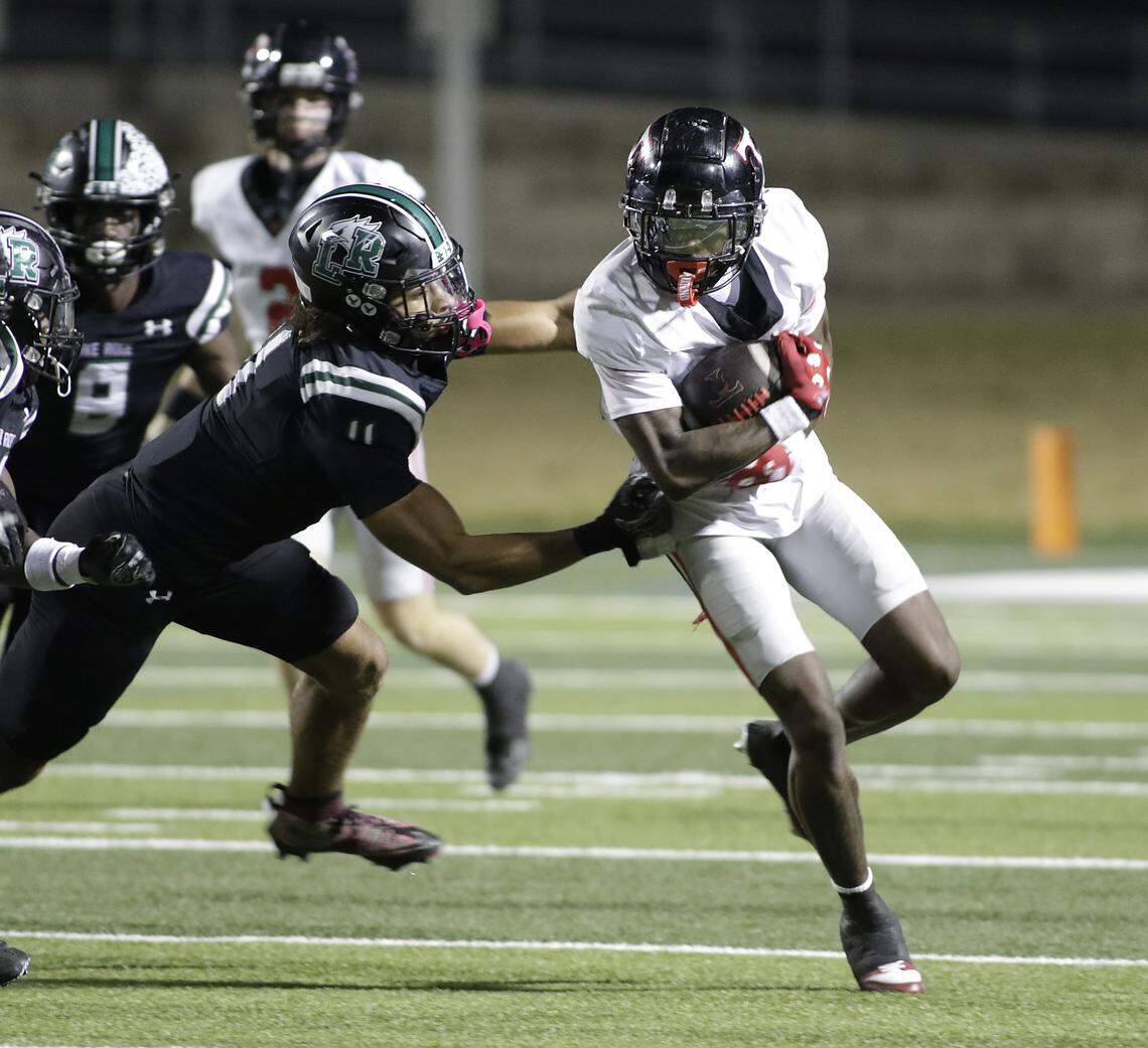 Mansfield Lake Ridge linebacker Jayden Cupitt (11) zeroes in on Euless Trinity running back Keondre Dixon (4) during their Class 6A Division I bi-district game on Friday, November 14, 2025 at Newsom Stadium in Mansfield Texas.