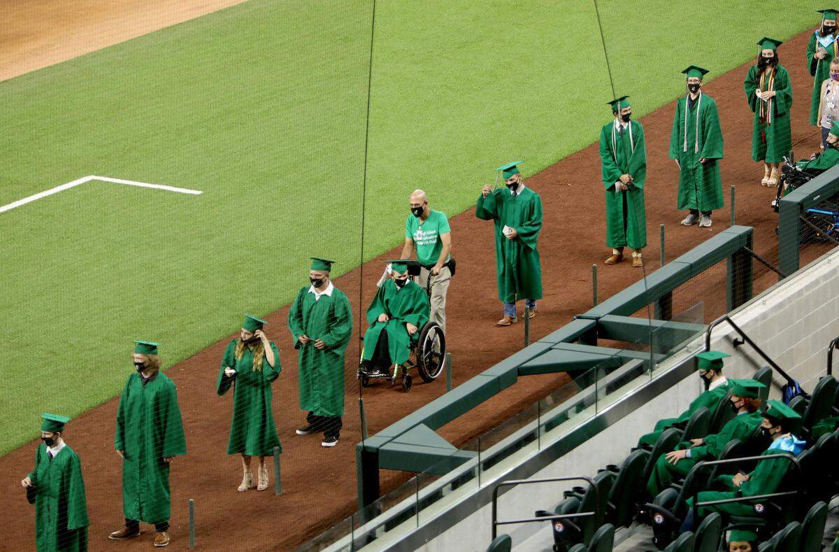 Azle High School seniors walk during their commencement ceremony at Globe Life Field on Saturday, May 30, 2020.