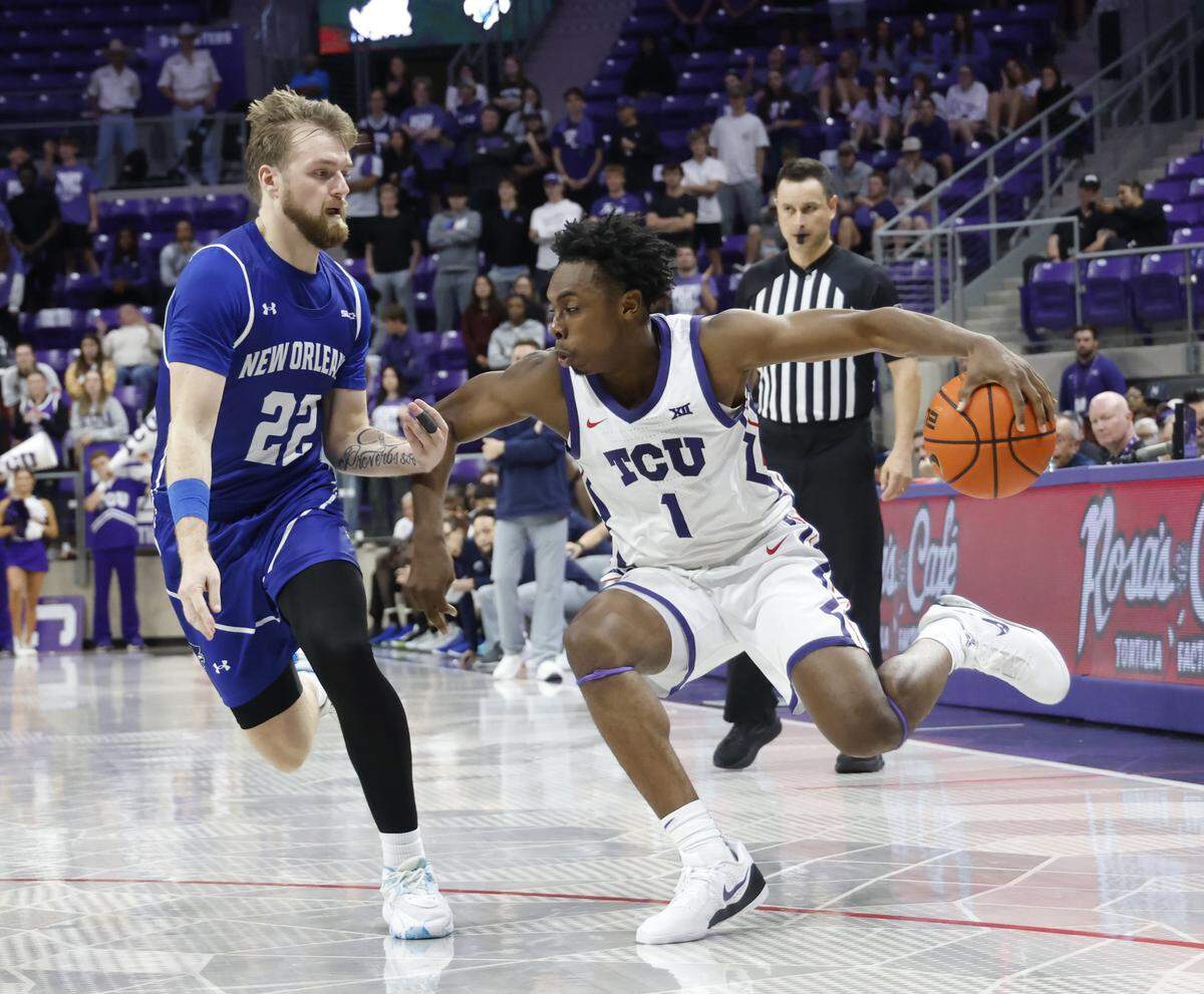 TCU guard Jayden Pierre (1) drives the ball against New Orleans guard Coleton Benson (22) during the second half of a NCAA basketball game between New Orleans University and TCU at Schollmaier Arena in Fort Worth, Texas, Monday Nov. 03, 2025. The Horned Frogs dropped their home opener 78-74 to the Privateers.