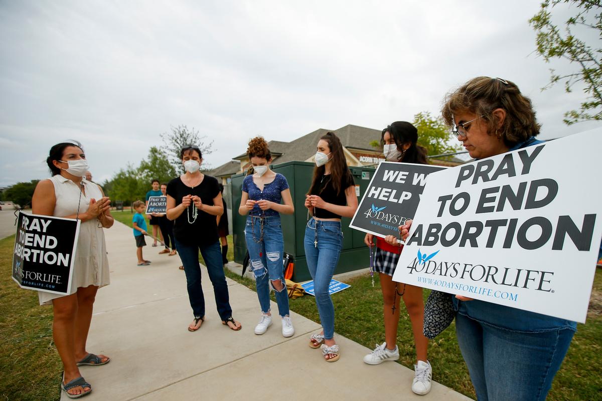 FILE - Anti-abortion demonstrators pray and protest outside of a Whole Women’s Health of North Texas in 2021 in McKinney. (AP Photo/Brandon Wade, File)