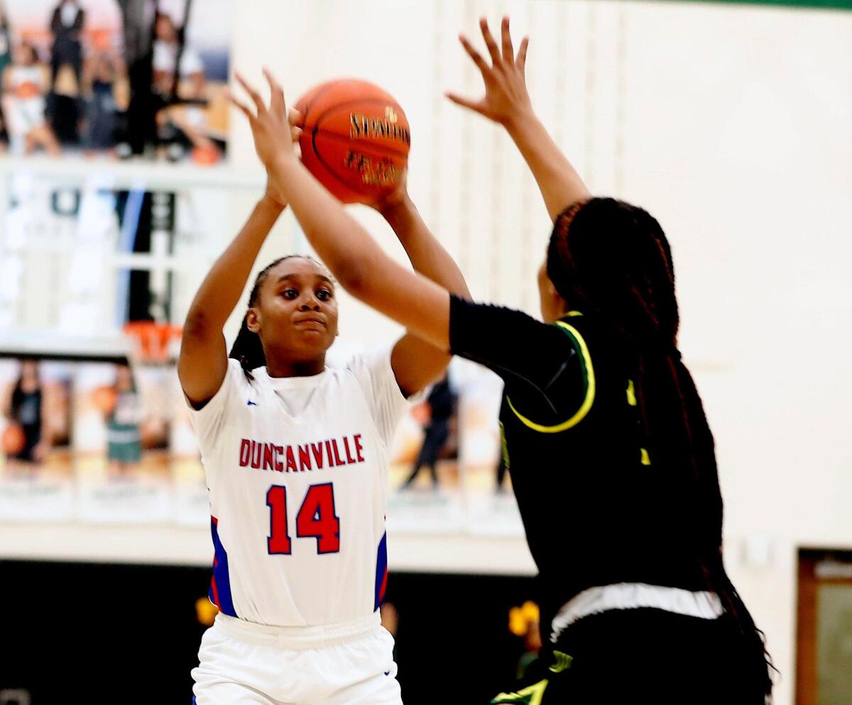 Duncanville guard Kaila Kelley (14) drops in two over the defense of DeSoto guard Ayanna Thompson (20) during the second half of the 6A Region II Regional Final basketball game at Waxahachie High School in Waxahachie, Texas, Tuesday, March 02, 2021. DeSoto defeated Duncanville . 52-39. (Special to the Star-Telegram Bob Booth)