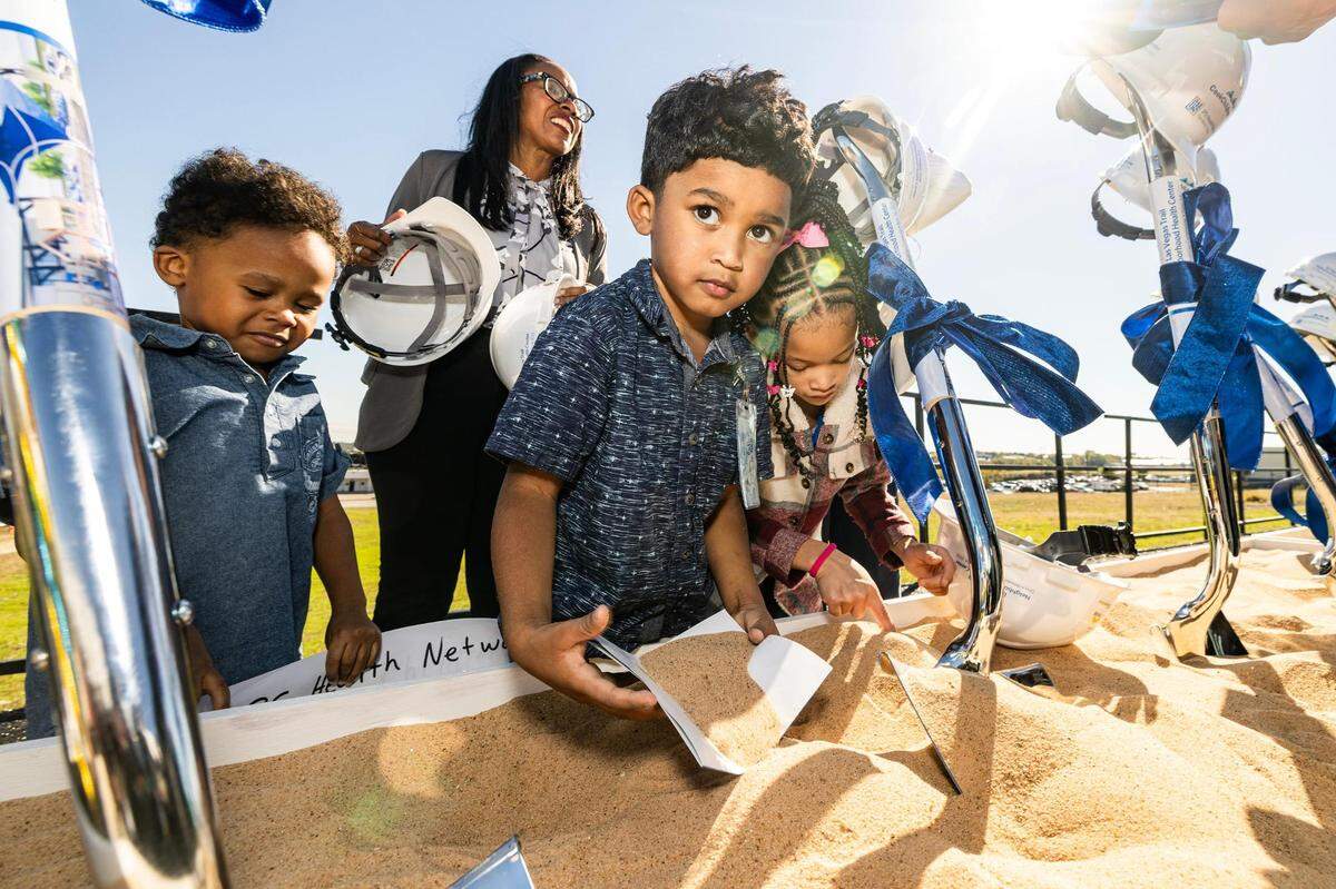 Western Hills Pre-K students Marques Cook Jr., 4, Darius Cotter, 4, and Peyton Arbell, 7, participate in the groundbreaking ceremony for the Las Vegas Trail Neighborhood Health Center in Fort Worth on Tuesday, Nov. 14, 2023.