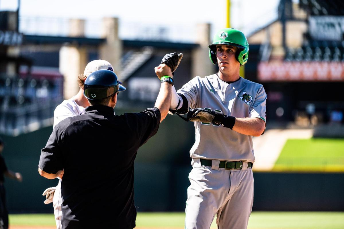 Tyler white fist bumps coach Zach Sellers after his hit during the UIL 6A baseball state semifinal between Southlake Carroll and Fort Bend Ridge Point at Dell Diamond in Round Rock on June 10, 2022.