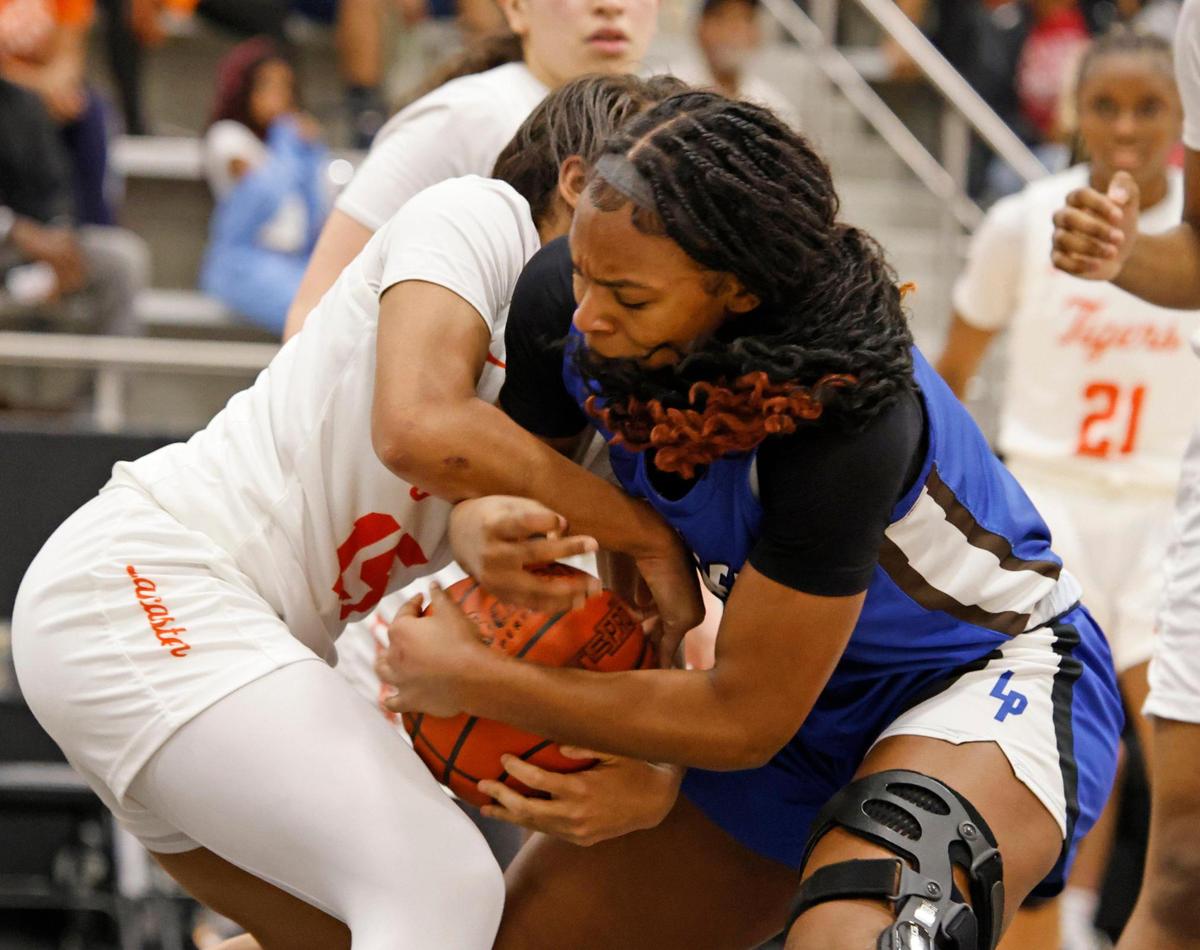 Lancaster guard Mckenzie White (15) and Fort Worth Boswell guard Seleste Massey (3) battle for the ball during the first half of the UIL Class 6A D2 state semifinal girls basketball game at The Colony High School in The Colony, Texas, Tuesday, Feb. 25, 2025.