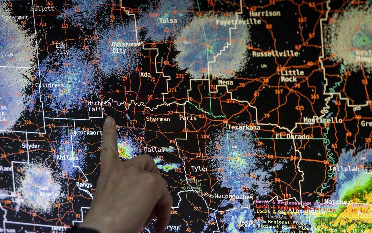 Senior Service Hydrologist Amanda Schroeder points to a reflectivity image of the area at the National Weather Service Fort Worth office on Friday, May 8, 2026 in Fort Worth, Texas. The image displays the intensity of the precipitation.