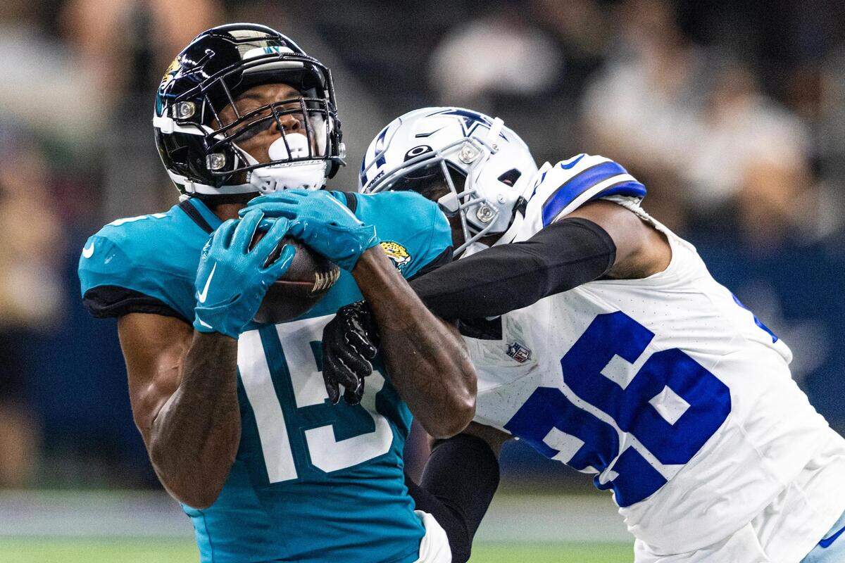 Jacksonville Jaguars wide receiver Tim Jones (15) goes for a catch over Dallas Cowboys defender DaRon Bland (15) during the first preseason game between the Dallas Cowboys and Jacksonville Jaguars at AT&T Stadium in Arlington, Texas on Saturday, Aug. 12, 2023.