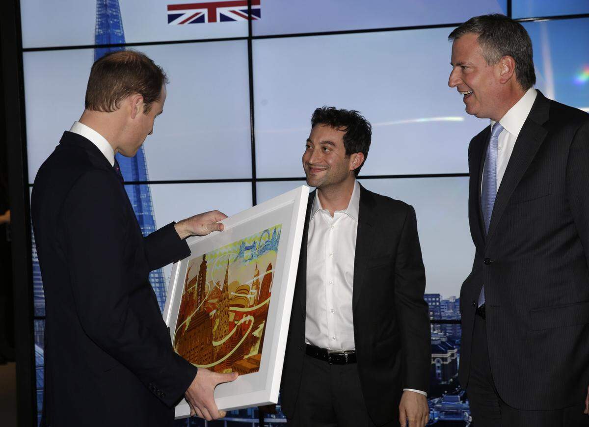 Shutterstock CEO Jon Oringer, center, presents a gift to Prince William, the Duke of Cambridge, left, while New York City Mayor Bill de Blasio looks on during a reception called “Innovation is Great” in New York, Tuesday, Dec. 9, 2014. (AP Photo/Seth Wenig, Pool)