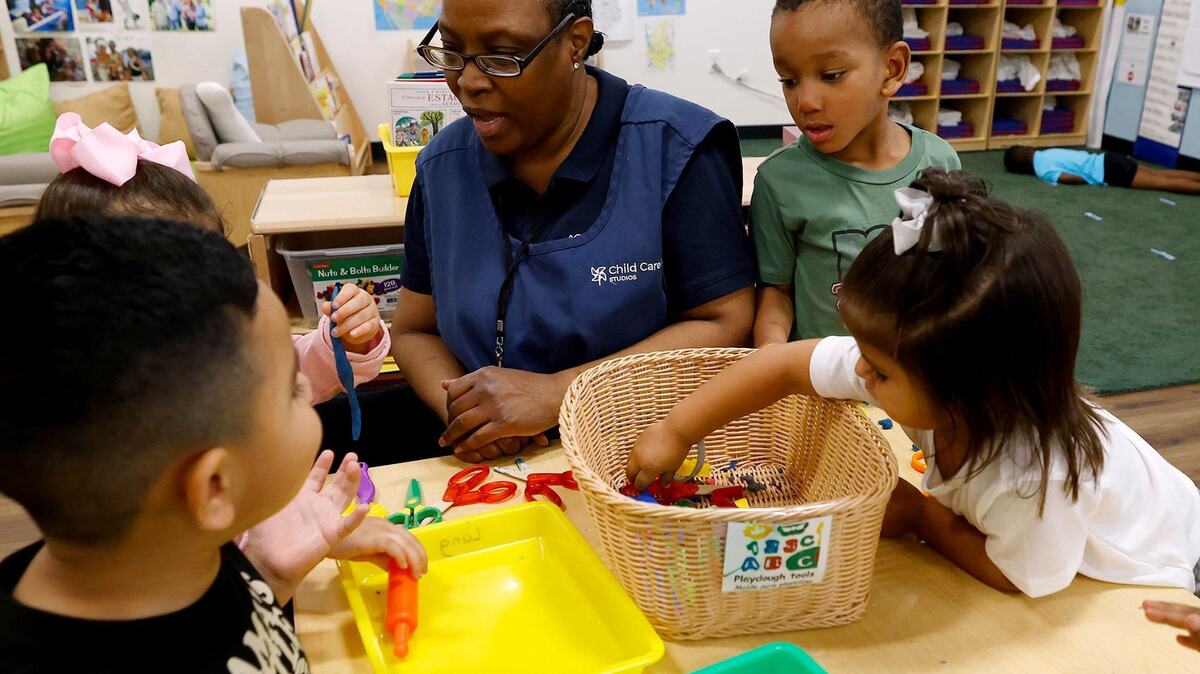Teacher assistant Candice Franklin helps children as they play at a station while attending pre-K at The Morris Foundation Child Development Center on Sept. 24, 2024. Fort Worth ISD is expanding its pre-K partnerships by launching a new model where a nonprofit organization will oversee a network of child care centers.