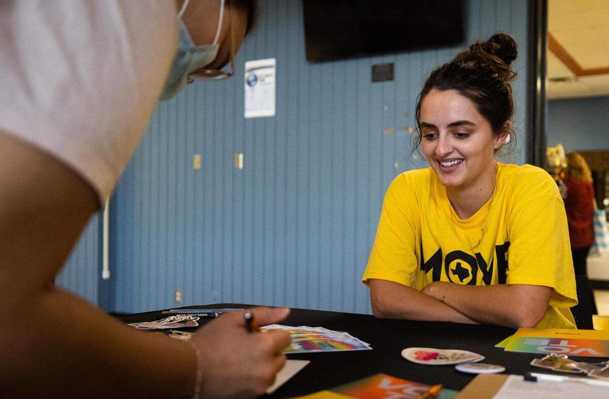 Lydia Faith, field canvasser with MOVE Texas, watches as Madison Sherrod fills out a voting card Thursday at the TCC South Campus in Fort Worth.