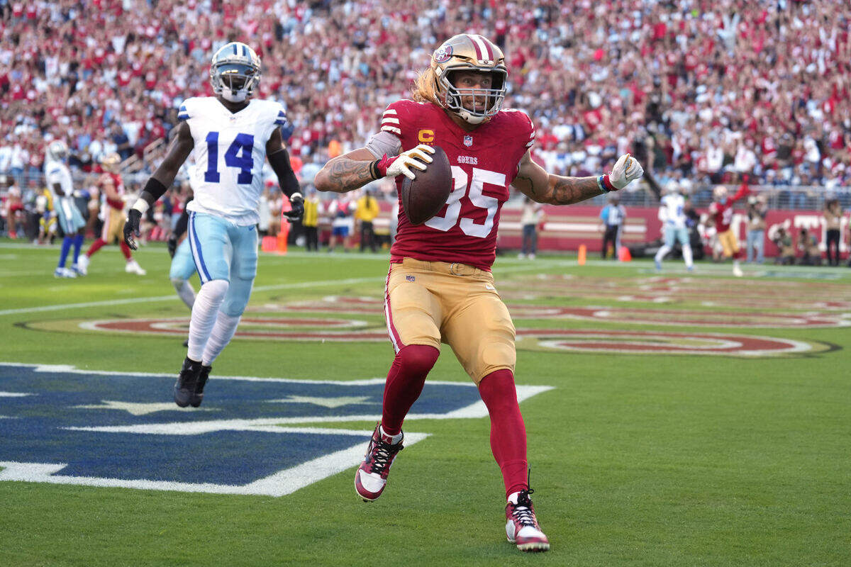 San Francisco 49ers tight end George Kittle (85) reacts after catching a touchdown pass against Dallas Cowboys safety Markquese Bell (14) during the first quarter at Levi’s Stadium.