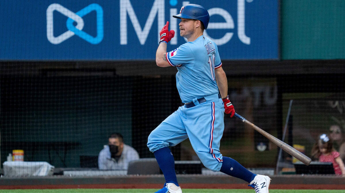 Texas Rangers third baseman Brock Holt, from Stephenville, follows through on a go-ahead RBI single that scored David Dahl and Isiah Kiner-Falefa during the eighth inning Sunday in Arlington.