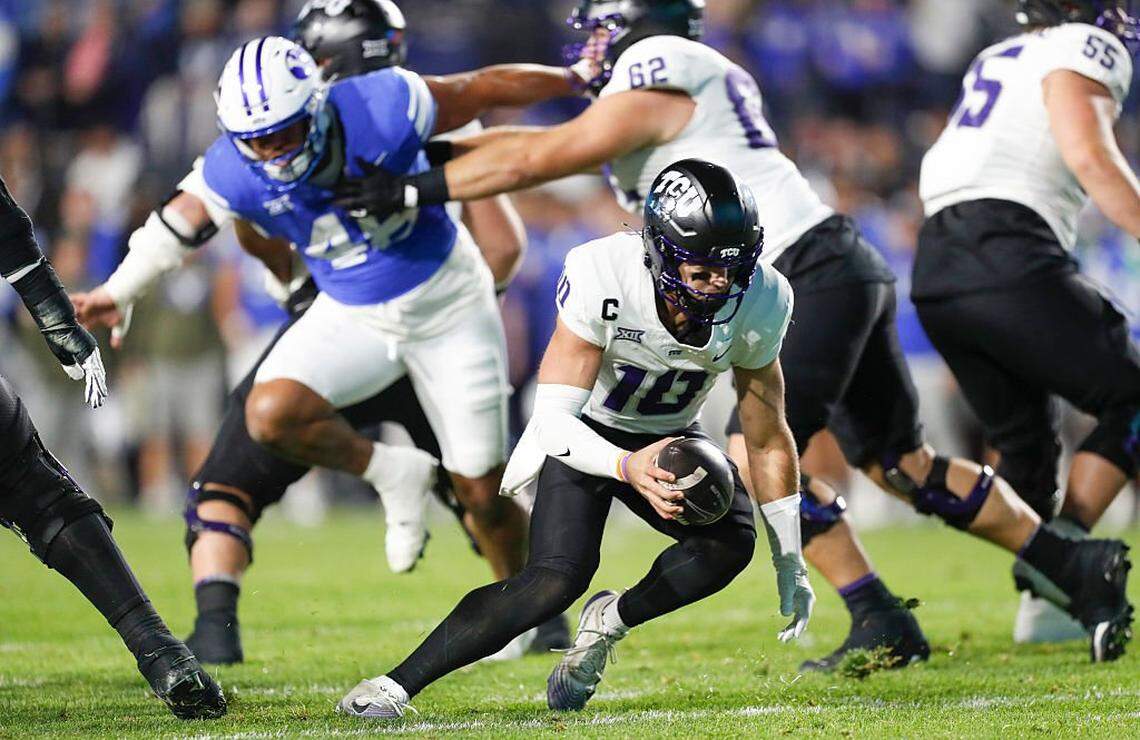 PROVO, UT - NOVEMBER 15: Josh Hoover #10 of the Texas Christian University Horned Frogs escapes pressure from Viliami Po'uha #45 of the Brigham Young Cougars during the first half of their game at LaVell Edwards Stadium on November 15, 2025 in Provo, Utah. (Photo by Chris Gardner/Getty Images)