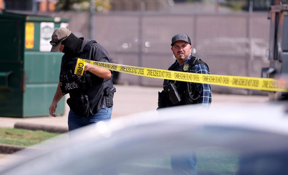 Law enforcement investigate the scene where a shooting at an Immigration and Customs Enforcement facility occurred in Dallas on Wednesday, Sept. 24, 2025.