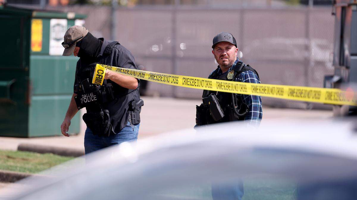 Law enforcement investigate the scene where a shooting at an Immigration and Customs Enforcement facility occurred in Dallas on Wednesday, Sept. 24, 2025.