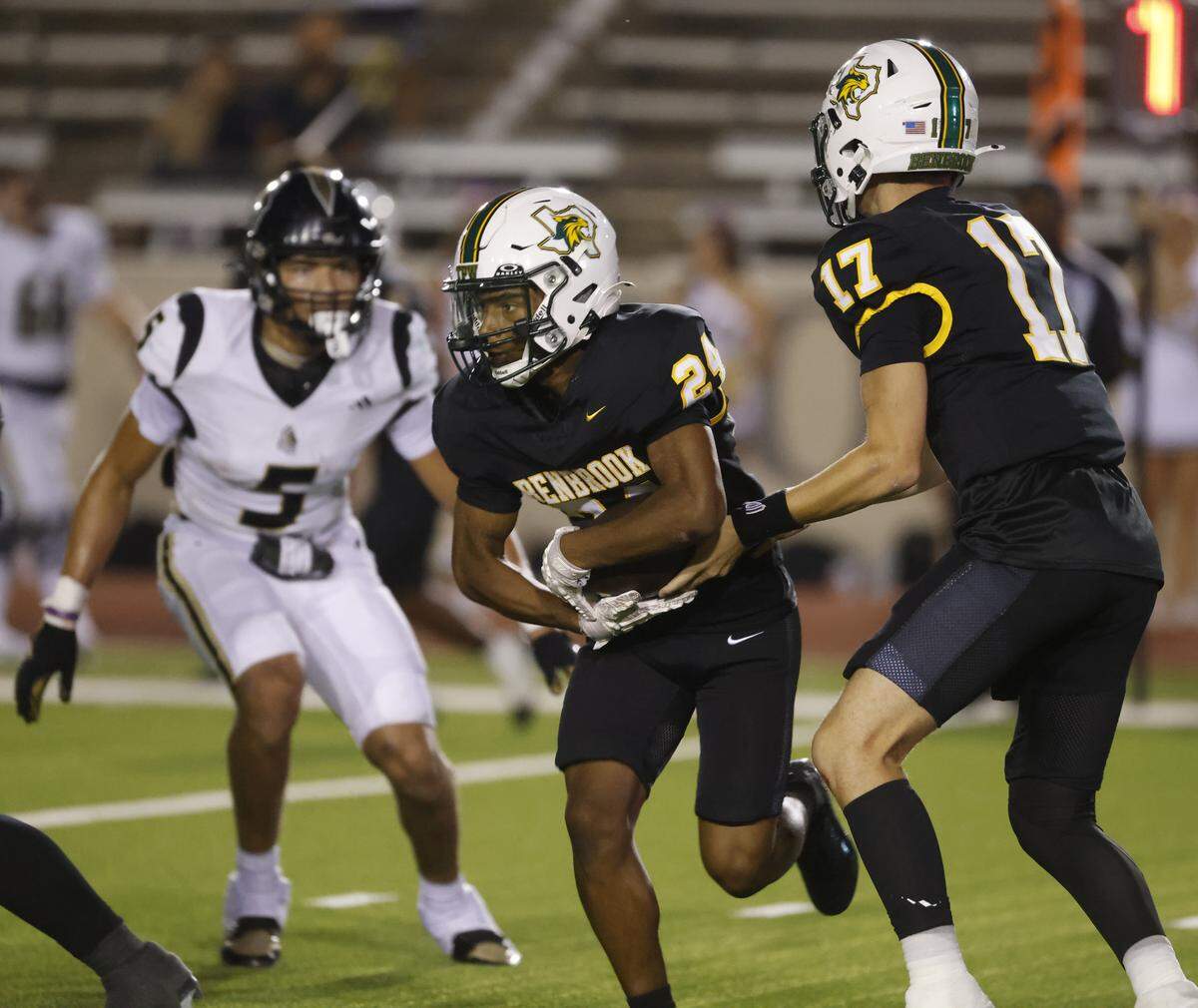 Benbrook running back Quentin Thomas (24) takes the ball to try the left side of the line during the first half of a UIL football game between Eagle Mountain and Benbrook at Farrington Field in Fort Worth, Texas, Friday, Sept. 26, 2025.