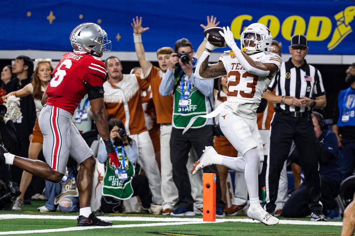 Texas running back Jaydon Blue (23) catches a touchdown pass from quarterback Quinn Ewers (3) in the second quarter of the College Football Playoff semifinal game between Ohio State and Texas at AT&T Stadium in Arlington on Friday, Jan. 10, 2025.