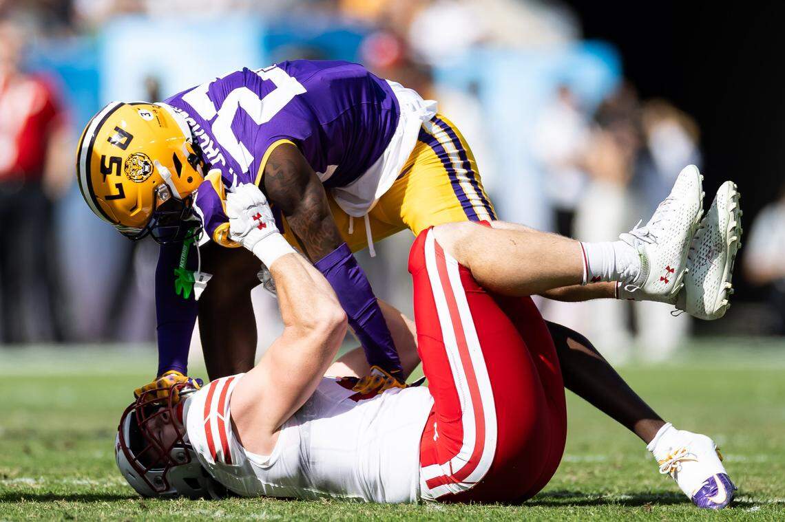 Jan 1, 2024; Tampa, FL, USA; LSU Tigers safety Kylin Jackson (23) tackles Wisconsin Badgers linebacker Marty Strey (32) during the first half at Raymond James Stadium. Mandatory Credit: Matt Pendleton-USA TODAY Sports
