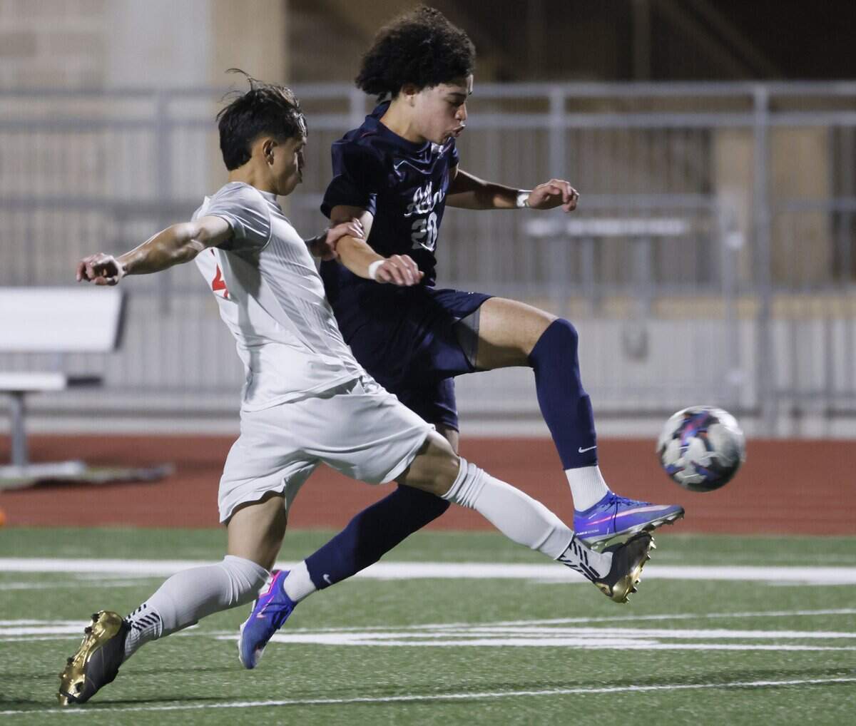 Arlington Sam Houston Angel Maldonado (4) and Allen midfielder Ivan Wright (20) battle for the ball during the first half of a UIL area round boys soccer playoff game at Tommy Standridge Stadium in Carrollton, Texas, Tuesday, March 24, 2026.