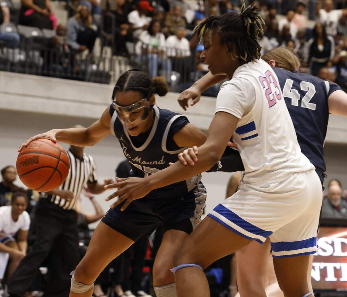 Flower Mound guard Maci Pringle (23) grabs a defensive rebound defended by North Crowley forward Mecca Crawford (23) during the second half of a UIL Class 6A Division I girls regional final basketball playoff game at Arlington ISD Athletics Center in Arlington, Texas, Friday Feb. 27, 2026.