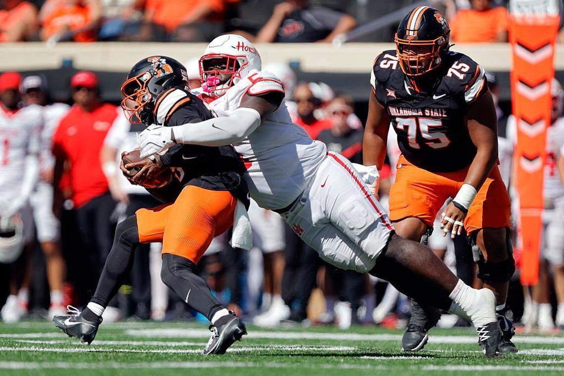 STILLWATER, OK - OCTOBER 11: Nose guard Carlos Allen Jr. #5 of the Houston Cougers stops quarterback Sam Jackson V #18 of the Oklahoma State Cowboys without a gain on 3rd-and-9 in the fourth quarter at Boone Pickens Stadium on October 11, 2025 in Stillwater, Oklahoma. Houston won 39-17. (Photo by Brian Bahr/Getty Images)